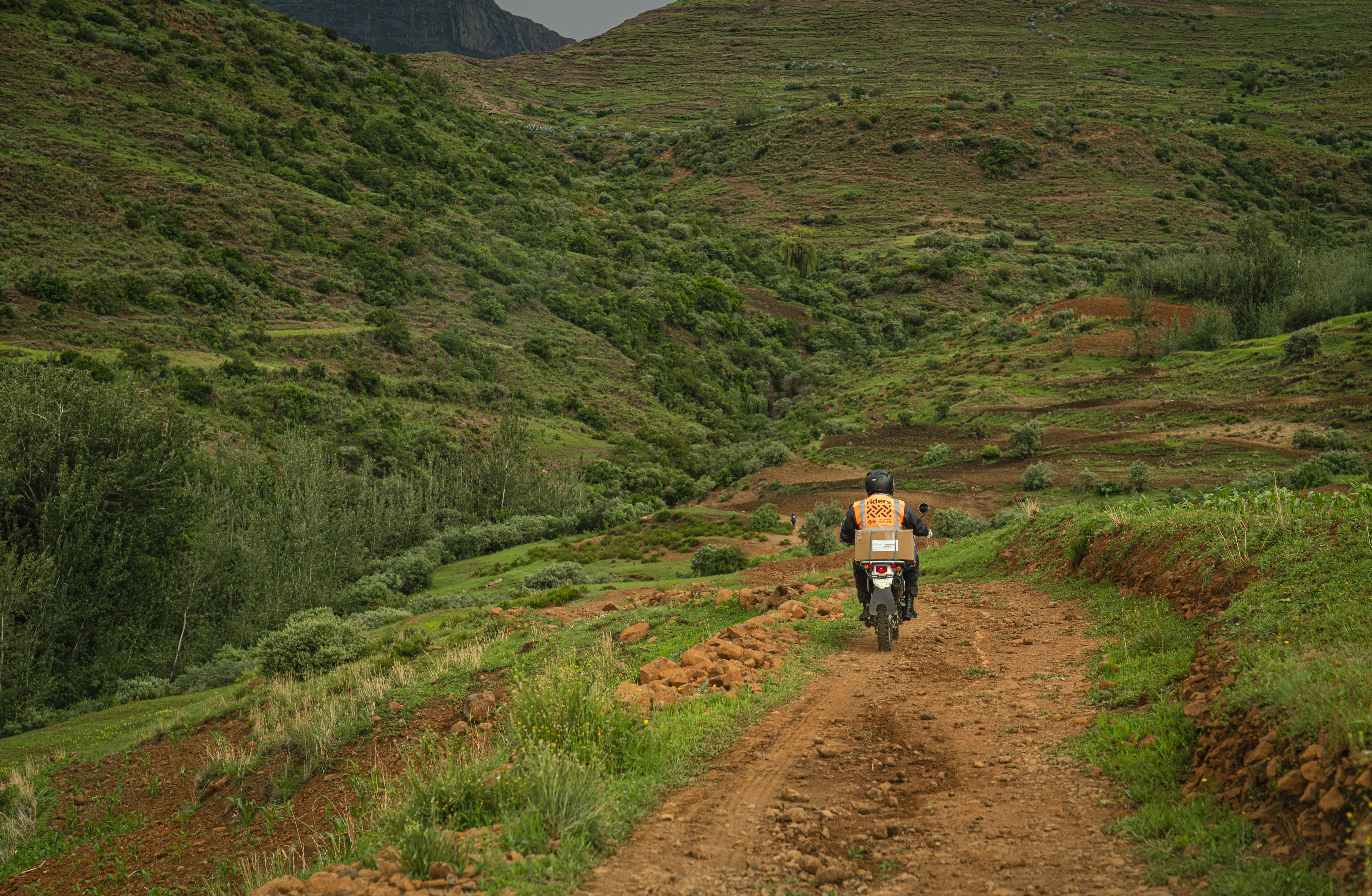 A Rider for Health motorcycling along a rough tract in the Berea district of Lesotho