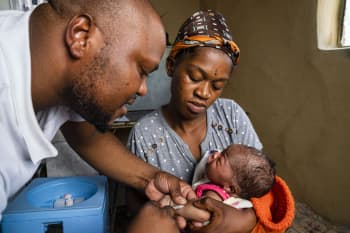 A Riders for Health worker administers care to a newborn in Mafeteng, Lesotho.